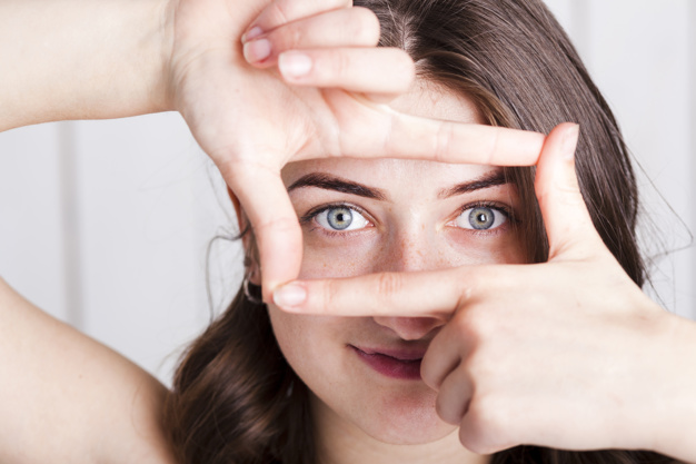 woman-framing-eyes-with-fingers_23-2147835579