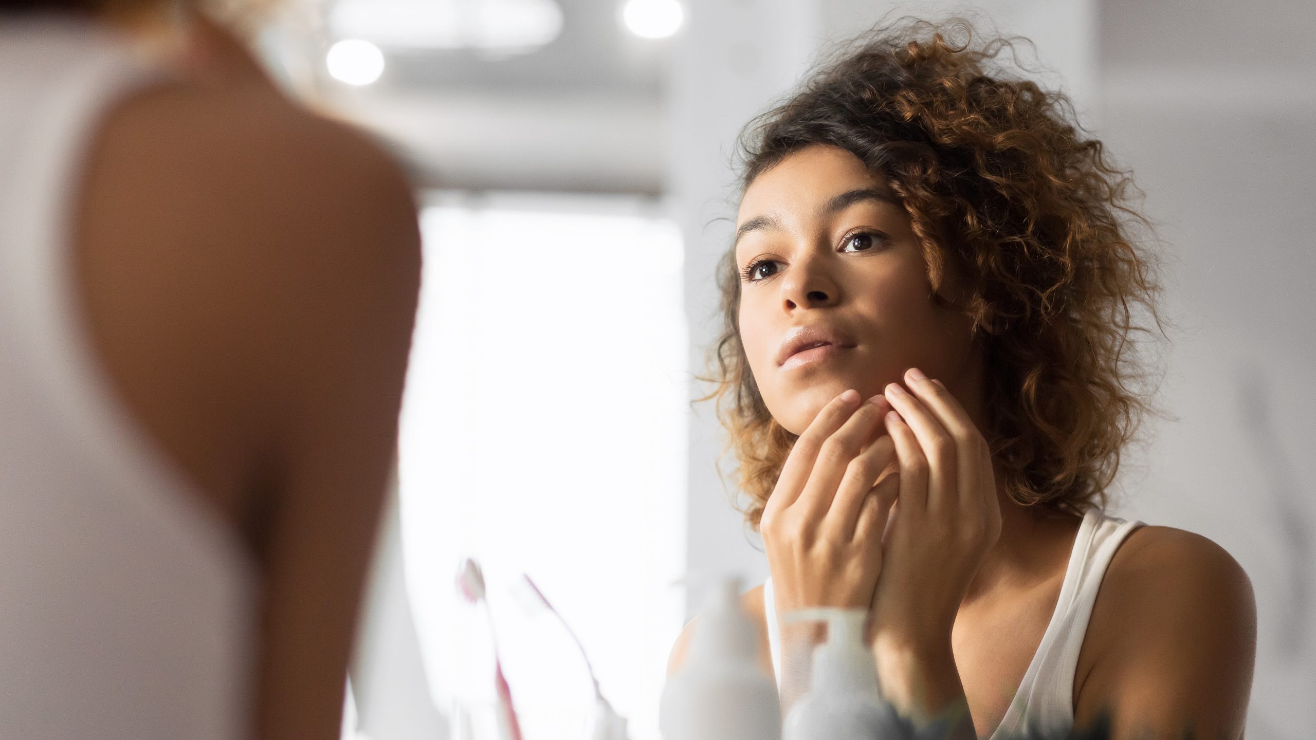 Black Millennial Girl Looking At Pimple In Bathroom, Panorama