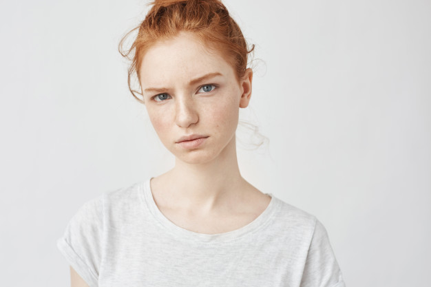 portrait-young-tender-redhead-woman-with-healthy-freckled-skin-wearing-grey-top-with-serious-expression_176420-8019