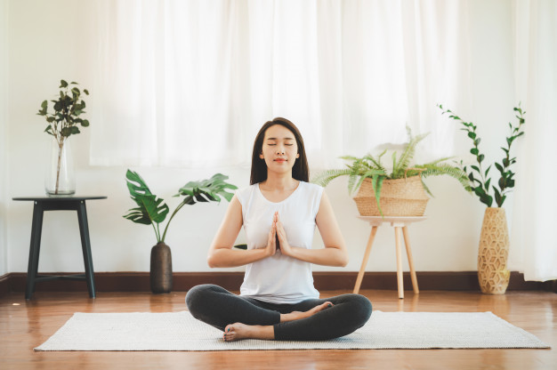 asian-woman-doing-yoga-meditation-home_34840-753